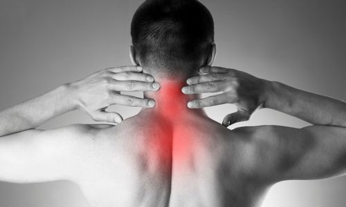 Image of back of neck with red indicating pain and hands lifted above the shoulders