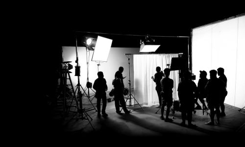 Black and white image of a film production team, who are busy working but ready to relax with an on-site massage from Body Mechanics.